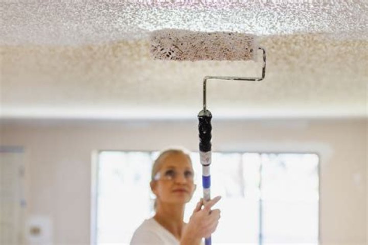 How do you prevent roller marks when painting a ceiling?