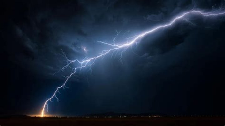 What is the difference between a lightning stroke and a lightning flash?